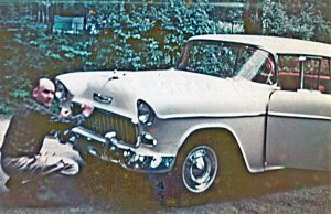 William M. Raymond, Jr. checks the license plate on his new 1955 Chevrolet Bel Air Hardtop Convertible.